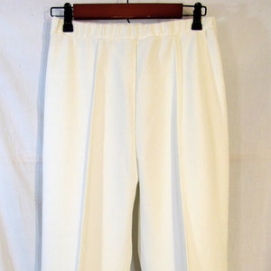 The front crease on pants was a different and new style for mens pants at  the time  Mens pants Pants Khaki pants