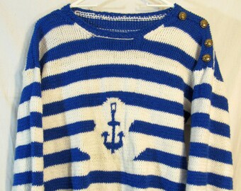 May include: A blue and white striped sweater with an anchor design and gold buttons on the shoulders.