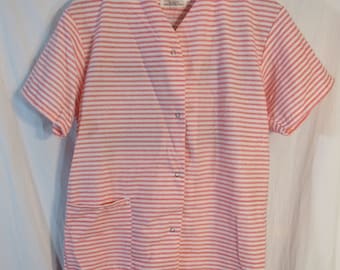 May include: A pink and white striped pajama set with a button-up top and long pants. The top has a pocket on the left side. The label reads "Sizes Unlimited".