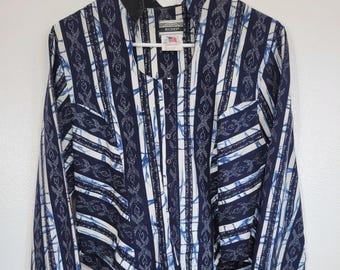 May include: A long-sleeved button-up shirt with a navy blue and white striped pattern. The shirt features a unique design with a high collar and black cuffs. The brand tag "Rockies" is visible.