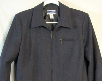 May include: A dark blue zippered jacket with a collar. The jacket has a pocket on the left side and a Pendleton label on the inside.