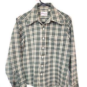 May include: A long-sleeved button-down shirt in a green and cream plaid pattern. The shirt has a pointed collar, a chest pocket, and white buttons. The brand name "Breed" is visible on the label.