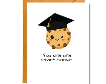 May include: A white card with a brown envelope. The card features a cartoon chocolate chip cookie wearing a black graduation cap. The text on the card reads "You are one smart cookie."