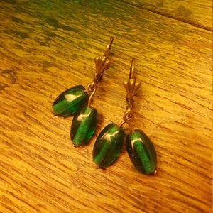 Green glass beads on antiqued brass hooks with lever back