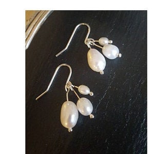 Three silver pearls on silver hooks