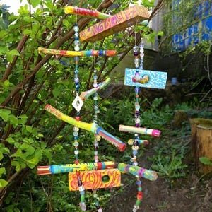 Mobile made of painted branches/wood scraps and beads/wind chimes