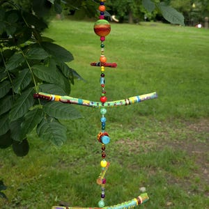 Mobile made of painted branches and wooden mushrooms, with beads in between/wind chime