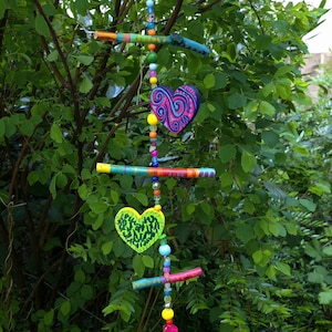 Hanging decoration made of painted branches and hearts made of wood and beads/wind chime/mobile