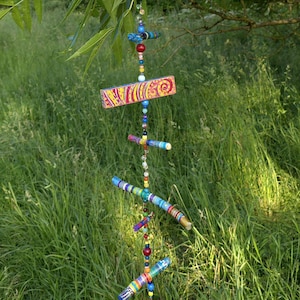Mobile made of painted branches/wood scraps and beads/wind chimes