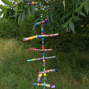 Mobile made of painted branches and beads/wind chimes