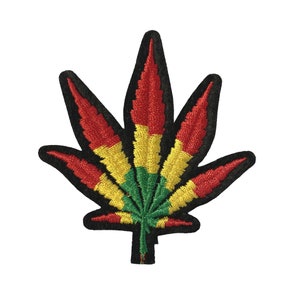 May include: A red, yellow, and green embroidered marijuana leaf patch. The patch is black outlined and has a black backing.