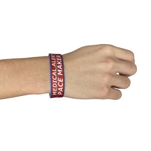 May include: Red and blue medical alert bracelet with the text "MEDICAL ALERT" and "PACE MAKER" on it.