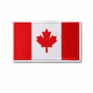 May include: Embroidered patch of the Canadian flag. The design features two red vertical bars, a white central panel, and a red maple leaf emblem. The patch is rectangular with a white border. The dimensions are in centimetres.