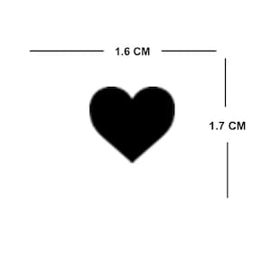 May include: A black heart-shaped sticker measuring 1.6 cm wide and 1.7 cm tall.