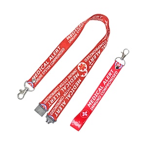 May include: Red lanyard with a silver clip and a medical alert message that reads "Medical Alert Immune System Compromised".