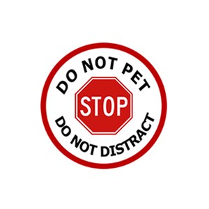 May include: A red and white circular sign with the text "DO NOT PET DO NOT DISTRACT" in black lettering. A red octagonal stop sign with the word "STOP" in white lettering is in the centre of the circle.