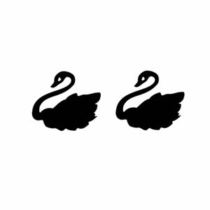 May include: Two black silhouette swans facing opposite directions.