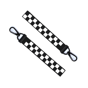 May include: Two black and white checkered keychains with black metal clasps.