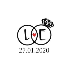 May include: Black and white illustration of two interlocking rings with the letters L and E inside. A red heart is between the rings. The date 27.01.2020 is below the rings.
