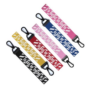 May include: Five colorful keychains with white diagonal stripes and the text "CLASS OF 2020". The keychains are in pink, blue, red, yellow, and black.