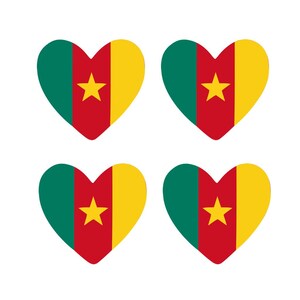 May include: Four heart-shaped designs featuring the flag of Cameroon. Each heart displays a vertical green stripe, a red stripe, and a yellow stripe, with a yellow star in the center. The hearts are arranged on a white background.