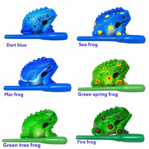 Peut inclure: Six hochets en forme de grenouille en bois avec diff&eacute;rentes couleurs et motifs. Les grenouilles sont bleues, vertes et jaunes avec des points rouges et blancs. Chaque grenouille a un b&acirc;ton en bois pour la secouer. Les grenouilles sont &eacute;tiquet&eacute;es "Dart blue", "Sea frog", "Mar frog", "Green spring frog", "Green tree frog", et "Fire frog".