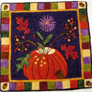 May include: A colorful needlepoint rug with a fall theme. The rug features a pumpkin, leaves, and flowers in a vase. The rug is surrounded by a border of colorful squares.