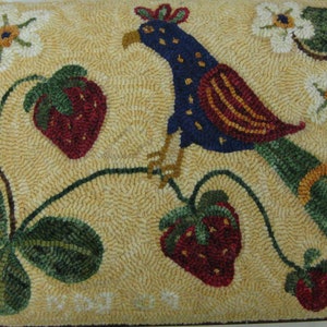 May include: A hand-stitched rug with a colorful bird perched on a branch with strawberries. The background is a light beige color. The bird has blue, red, and white feathers. The strawberries are red with green leaves.