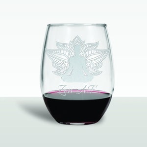 May include: A clear glass wine glass with a design of a person sitting in a lotus position with a mandala behind them. The text "Zen AF" is etched on the bottom of the glass.