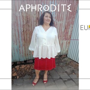 May include: A woman wearing a white blouse and a red skirt. The blouse has a V-neck and long sleeves. The skirt is red with white stitching. The text "APHRODITE" is at the top, and the "EUREKA DESIGNS" logo is on the right.