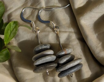 May include: A pair of silver earrings with stacked gray stones. Each earring has five stones stacked on top of each other.