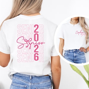 A woman wearing a white t-shirt with the text "SENIOR 2016" printed on it, along with a pink ribbon symbol.