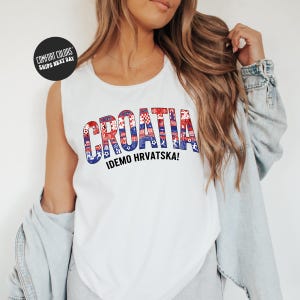 A woman wearing a white tank top with the word "Croatia" printed on it, along with the text "IDEMO HRVATSKA!" printed below.
