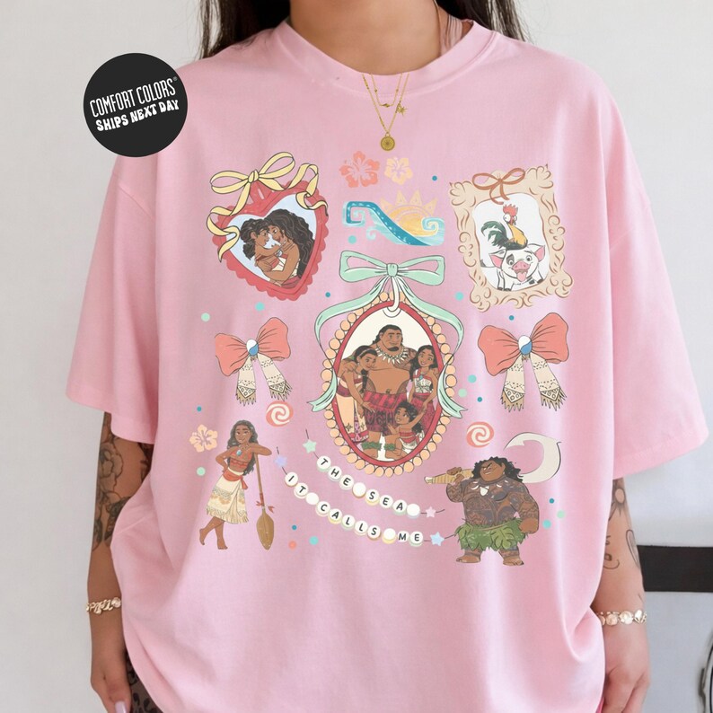 The image is a pink t-shirt with various cartoon-style illustrations and text, including characters and decorative elements.