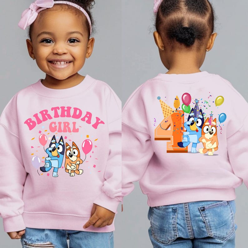 a little girl wearing a pink birthday sweatshirt