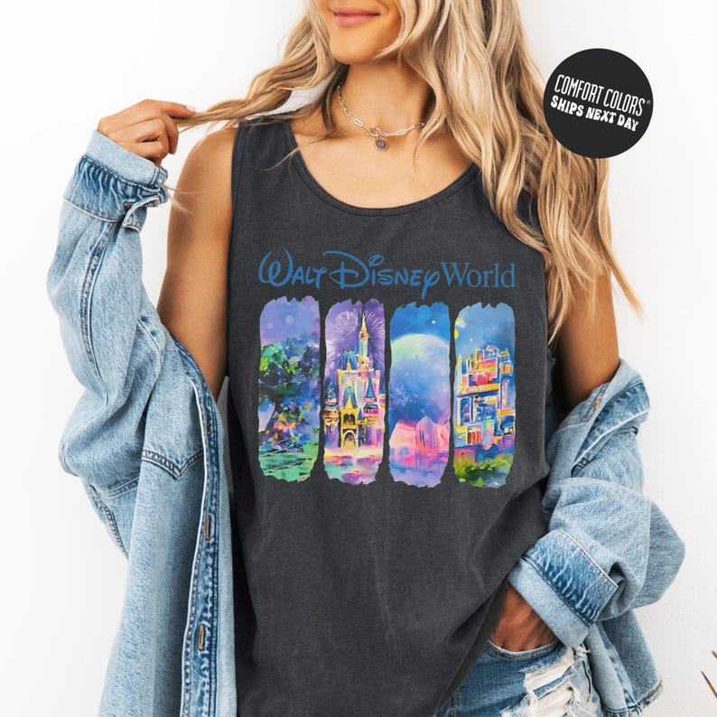 A woman wearing a black tank top with a graphic of Disney World buildings and a denim jacket.