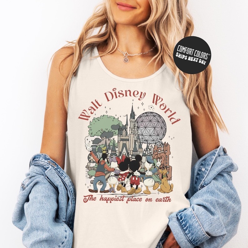 A woman wearing a white tank top with a graphic of Disney characters and the text "Walt Disney World" printed on it.