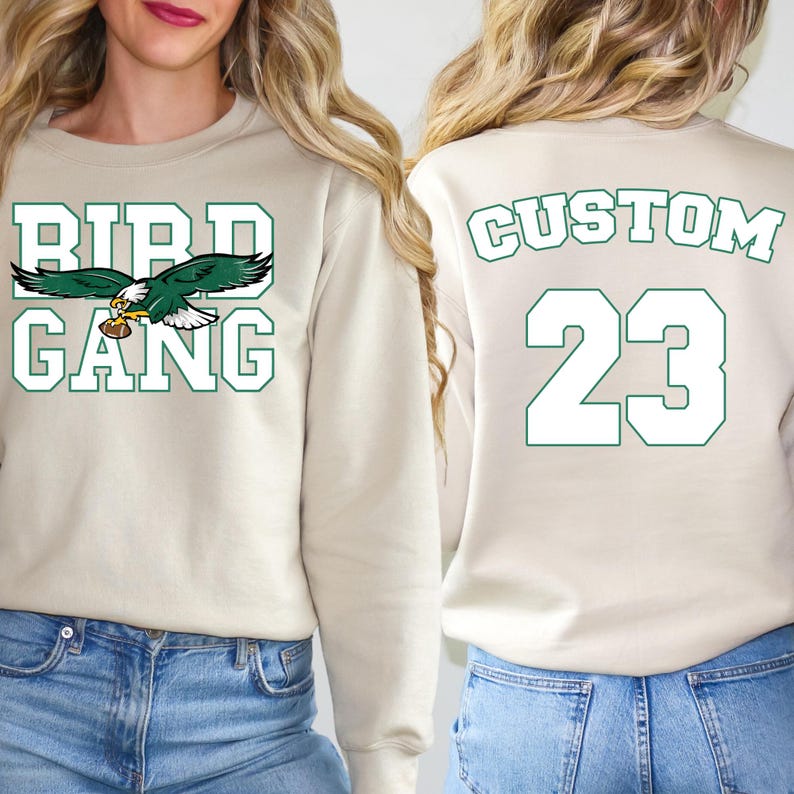 two women wearing matching sweatshirts with the text "BIRD GANG" and the number "23" printed on them.