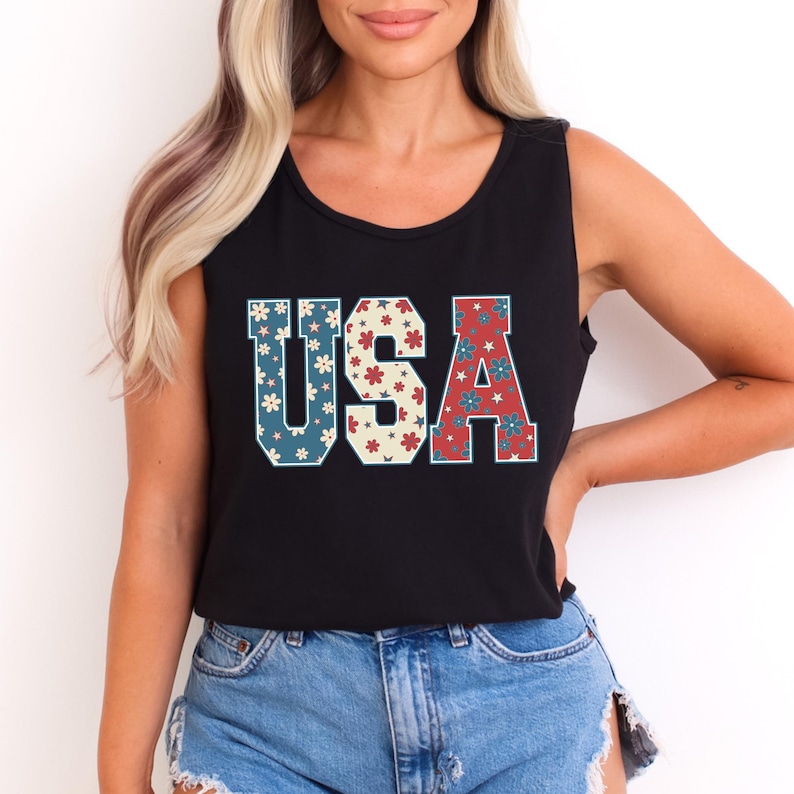 a woman wearing a black usa tank top