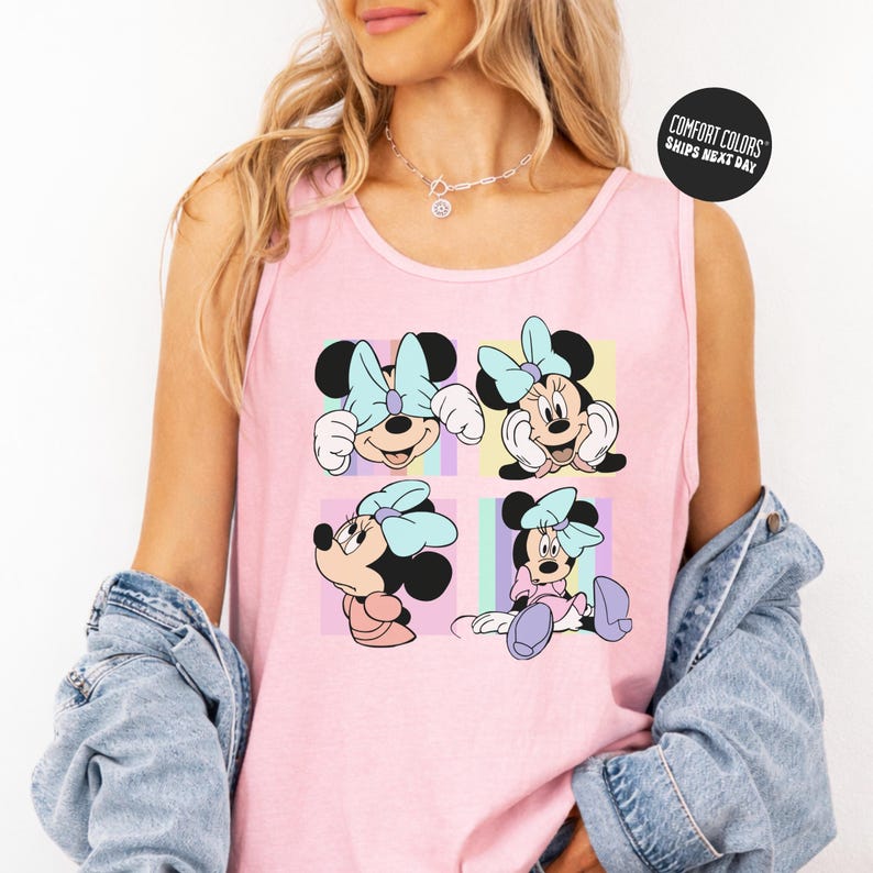 A woman wearing a pink tank top with a Minnie Mouse design and a denim jacket.