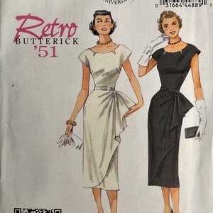 May include: A vintage sewing pattern for a dress, featuring two models wearing a white and a black dress with a similar design. The pattern is from Butterick and is labelled "Retro '51". The pattern number is B5880 and the size is E5 (14-16-18-20-22).