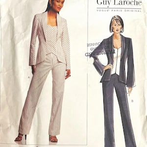 May include: Vogue Patterns sewing pattern featuring two Guy Laroche designs. One is a striped pantsuit, the other a solid dark suit. The pattern includes sizes 12, 14, and 16. The pattern number is 2736.