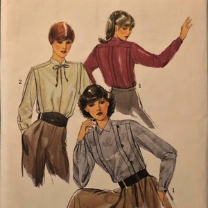 May include: A vintage sewing pattern for a blouse with a bow tie collar. The pattern is for size 12 and is called "Style" with the number 2938. The pattern shows three different models wearing the blouse in different colours.