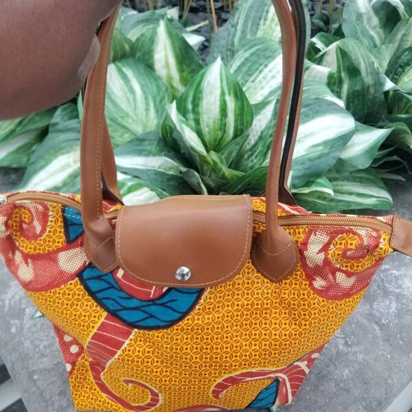 clearance: Medium fiber handbag with leather handles and clothing inside. Very colorful, very light , Gift for anyone