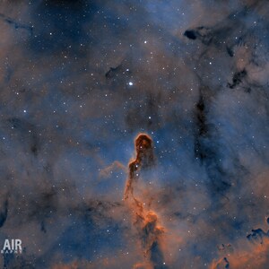 May include: A vibrant nebula in space, with a prominent dark pillar of gas and dust, surrounded by a swirling mix of blue and orange hues.