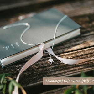 a book with a white ribbon tied around it