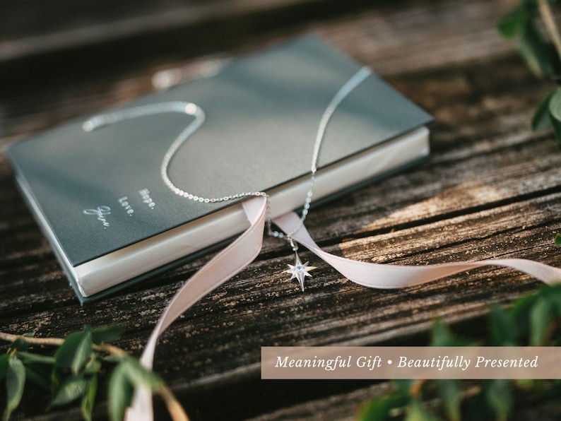 a book with a white ribbon tied around it