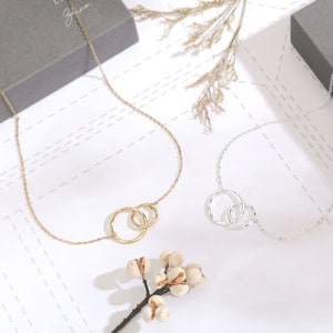 This 18 inches 14k gold and sterling silver necklace is a perfect wedding party gift for mother in law. It features two linked eternity circles, a symbol of infinite love and affection. It is packed in a jewelry box with a greeting card.