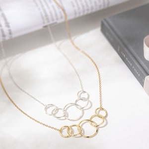 Fifty and fabulous! Make her 50th birthday unforgettable with our memorable interlocking circle necklace. This elegant 14k gold and sterling silver necklace is a timeless representation of love and friendship, making it a perfect gift for her.