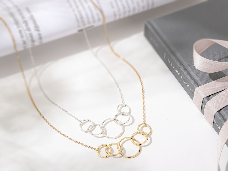 Fifty and fabulous! Make her 50th birthday unforgettable with our memorable interlocking circle necklace. This elegant 14k gold and sterling silver necklace is a timeless representation of love and friendship, making it a perfect gift for her.